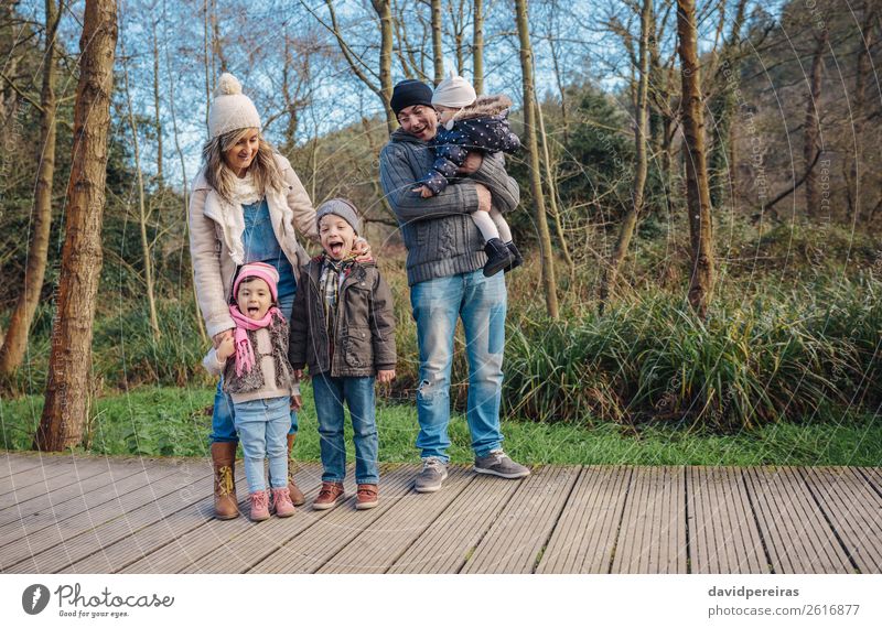 Happy family enjoying together leisure in the forest Lifestyle Joy Leisure and hobbies Winter Child Baby Boy (child) Woman Adults Man Parents Mother Father