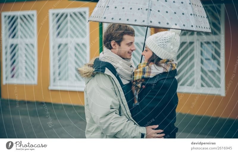 Young couple embracing outdoors under umbrella in a rainy day Lifestyle Happy Beautiful Winter Human being Woman Adults Man Family & Relations Couple Autumn