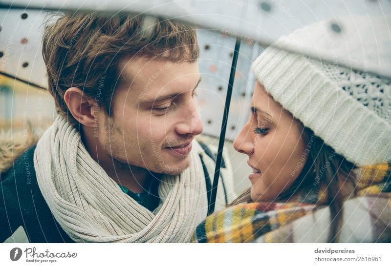 Couple under the umbrella in autumn rainy day Lifestyle Happy Winter Human being Woman Adults Man Family & Relations Autumn Rain Street Scarf Hat Kissing