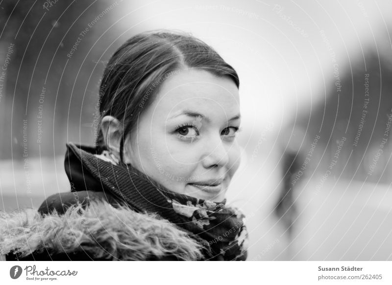 tart Feminine Head Hair and hairstyles Face Clothing Jacket Brunette Observe Rotate Impish Smiling Snowfall Winter Blur Black & white photo Copy Space right