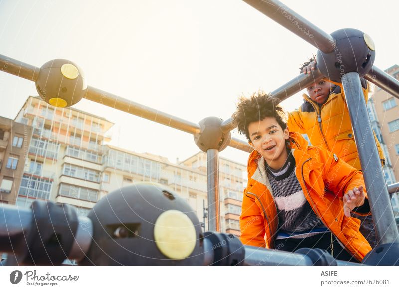 Children having fun in the urban playground Joy Happy Leisure and hobbies Playing Winter Climbing Mountaineering Boy (child) Man Adults Infancy Autumn Park