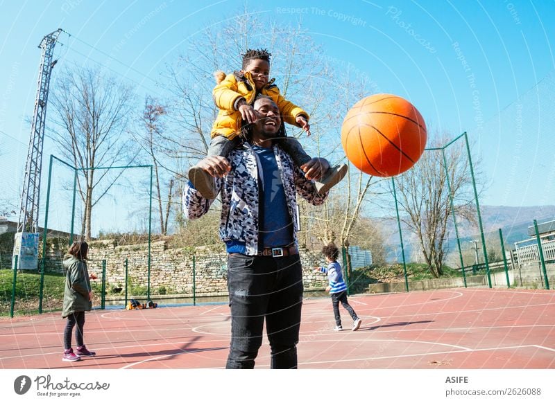 Dad and little son playing basketball Joy Happy Relaxation Leisure and hobbies Playing Winter Sports School Boy (child) Parents Adults Father Family & Relations