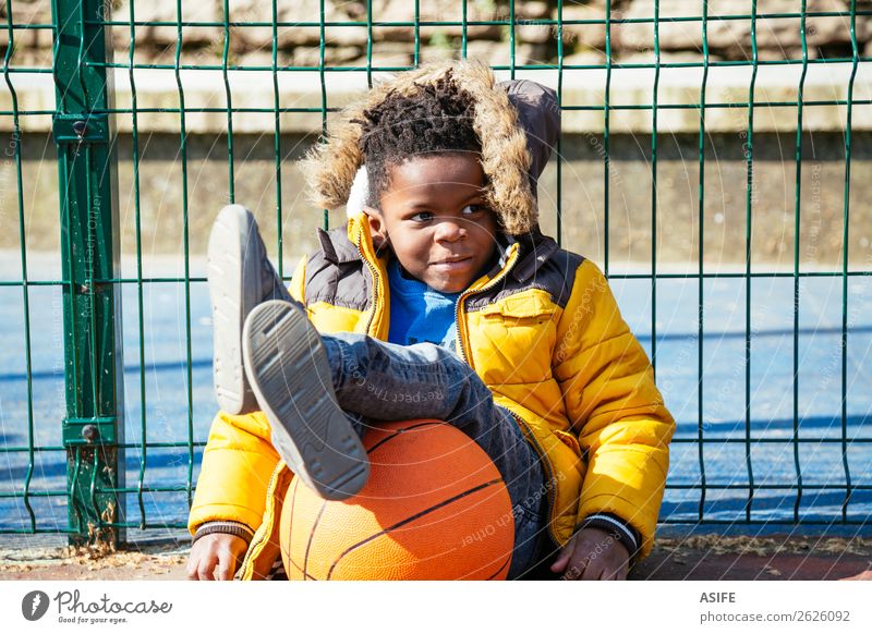 Funny little boy resting after playing basketball Joy Happy Relaxation Leisure and hobbies Playing Winter Sports Child School Boy (child) Infancy Autumn