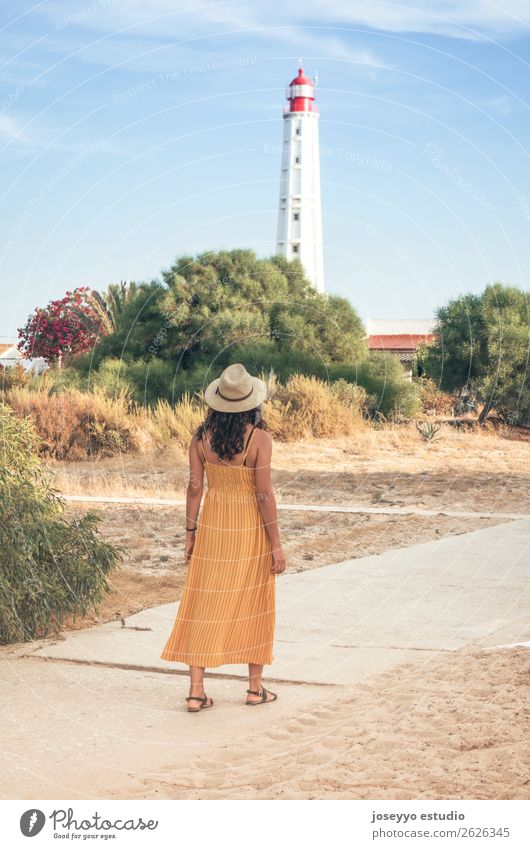 Woman walking with a lighthouse in the background Lifestyle Style Senses Relaxation Meditation Vacation & Travel Tourism Trip Summer Beach Ocean Island