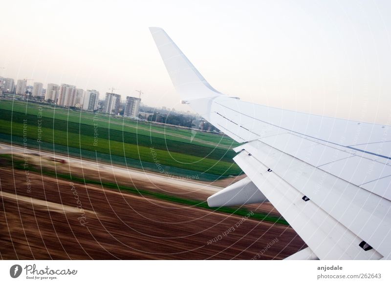 departure Vacation & Travel Far-off places Summer vacation Aviation Cloudless sky Field High-rise Means of transport Airplane Runway Airplane landing