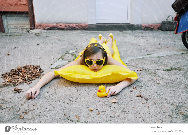 girl on yellow air mattress in backyard Summer Autumn Leaf Cold Longing Vacation & Travel Swimming & Bathing Air mattress Yellow Sunglasses Child Girl