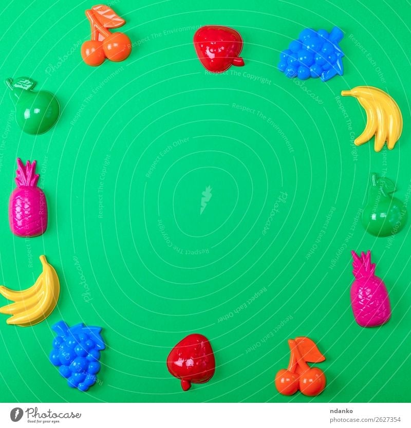 green background with childrens colorful toys Fruit Apple Design Joy Playing Summer Decoration Child Toys Collection Plastic Bright Cute Above Blue Yellow Green