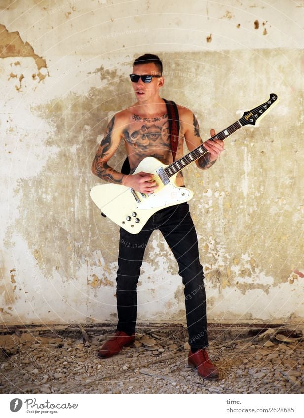 GuitarMan Masculine Adults 1 Human being Music Musician Ruin lost places Pants Tattoo Sunglasses Brunette Short-haired Observe To hold on Looking Playing Stand