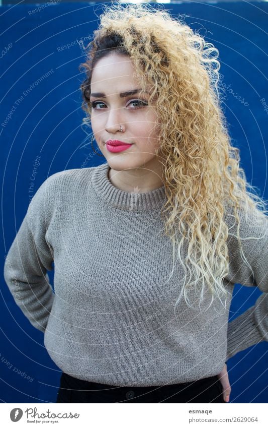 Portrait Young woman in blue background Lifestyle Feminine Youth (Young adults) Young man 13 - 18 years 18 - 30 years Adults Piercing Earring Long-haired Curl
