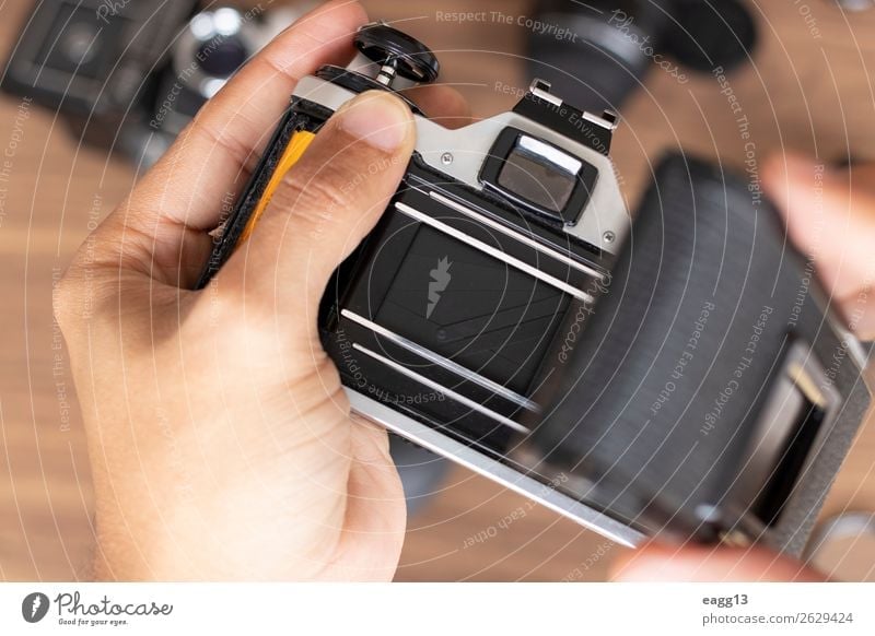 Placing photographic roll in a camera film Entertainment Work and employment Screen Camera Technology Human being Art Media Old Retro Black Creativity 35mm
