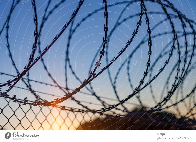 Fence with a barbed wire Freedom Camping Sky Metal Steel Rust Line Blue Black White Safety Protection Safety (feeling of) Dangerous War Penitentiary sharp