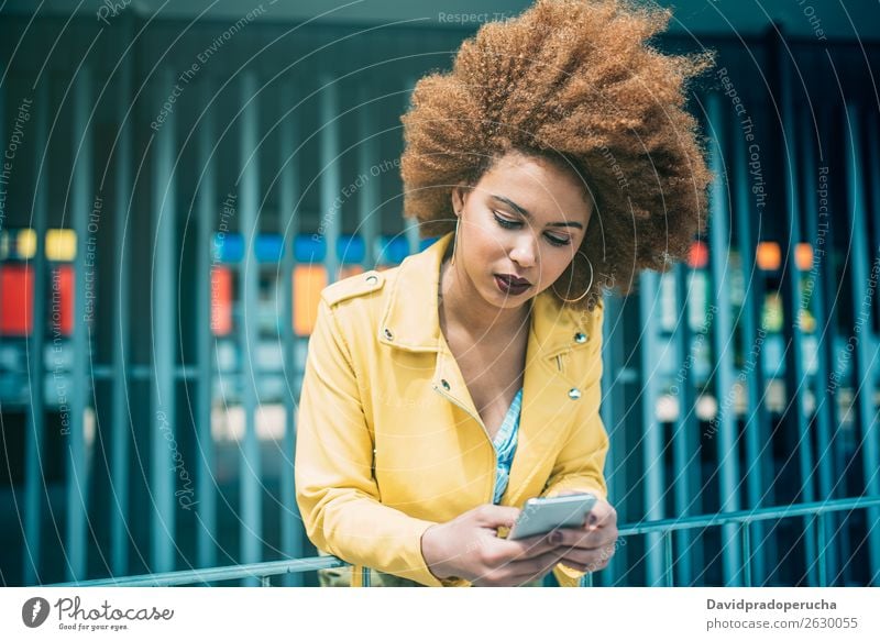 Mixed race woman sitting and on the mobile phone Woman Smiling Portrait photograph Black Cellphone Mobile Telephone PDA Technology Communication Internet