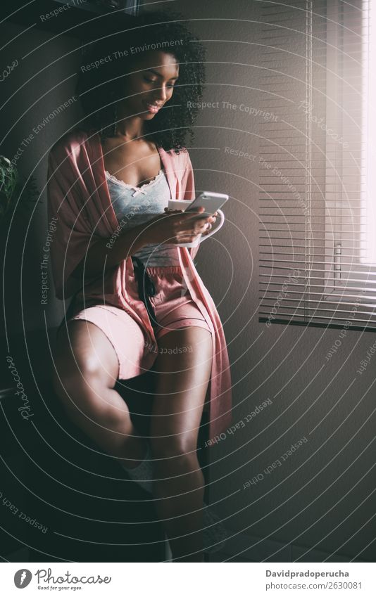 pretty black woman sitting at the window with cup of coffee and smartphone Woman Coffee Tea Window backlit PDA Sit Technology Telephone Mobile Communication
