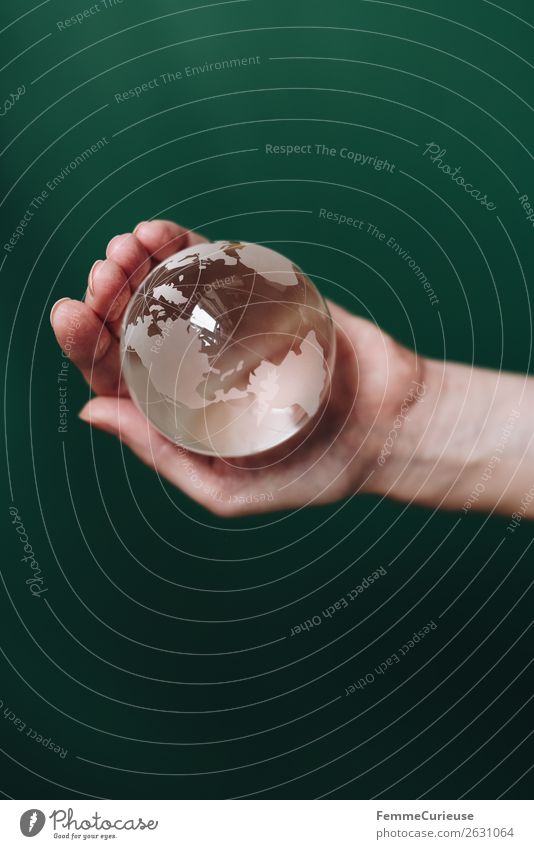 Hand with transparent globe in front of green background Nature Horizon Globe Earth Transparent To hold on Dark green North America South America Americas