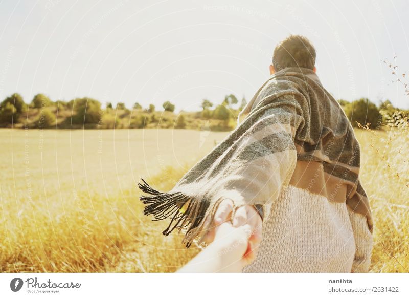 Man holding the hand of his couple in a field Lifestyle Wellness Harmonious Adventure Far-off places Freedom Summer Human being Masculine Adults