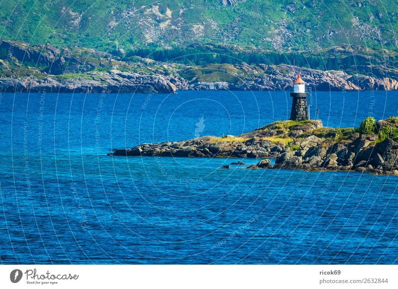 Coast with lighthouse on the Lofoten in Norway Relaxation Vacation & Travel Tourism Ocean Mountain Nature Landscape Water Grass Rock Lighthouse Blue Green Idyll