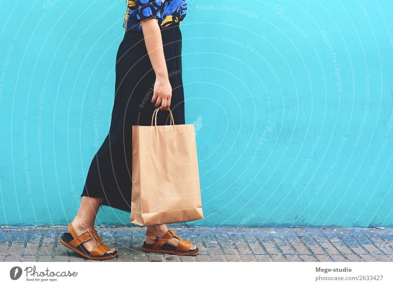 Young woman walking with shopping bags Lifestyle Shopping Style Joy Happy Beautiful Human being Woman Adults Hand Street Fashion Dress High heels Smiling