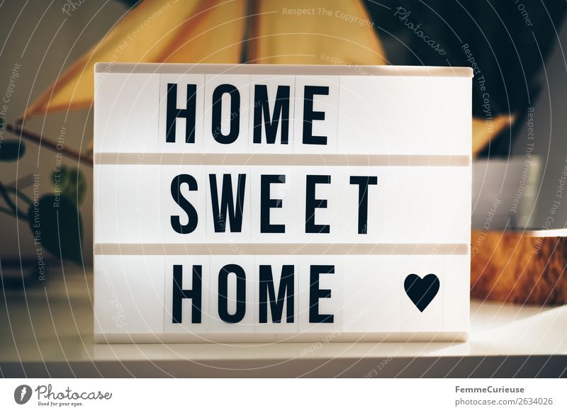 Lightbox with the words "home sweet home" Characters Living or residing Figure of speech word group Heart sideboard Decoration Sunbeam Colour photo
