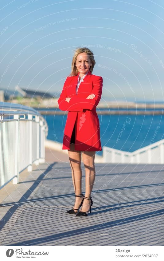 Adult woman standing on a bridge next to the sea Lifestyle Ocean Business Camera Feminine Woman Adults Arm Horizon Bridge Shirt Skirt Jacket Footwear High heels