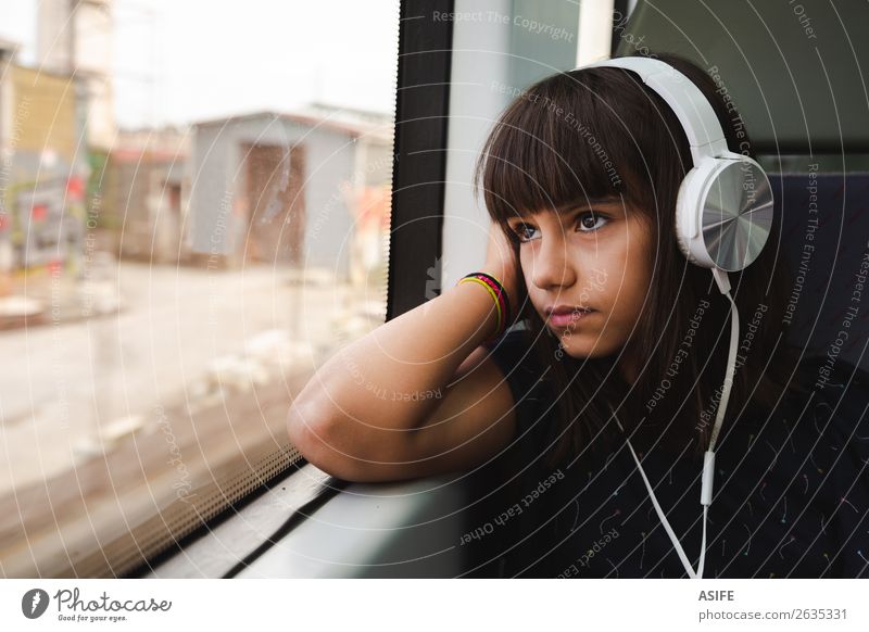 Little girl listening to music while travelling by train Beautiful Relaxation Leisure and hobbies Vacation & Travel Trip Music Child Headset PDA Technology
