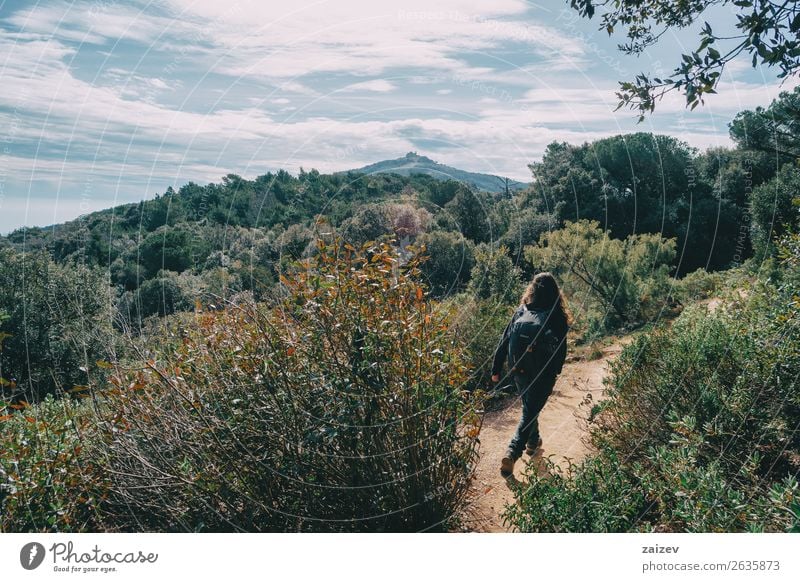 Woman walking in the distance on a trail among mountains on a sunny day Lifestyle Joy Happy Leisure and hobbies Vacation & Travel Tourism Adventure Freedom