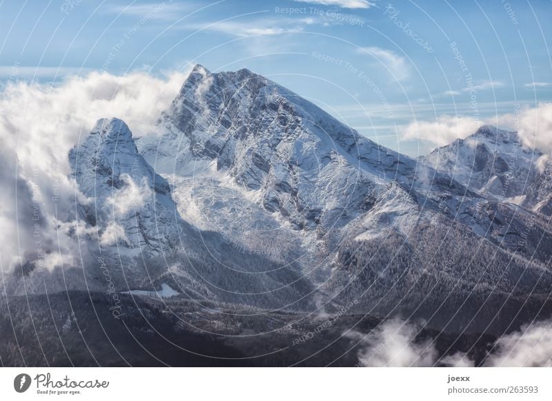 prehistoric rock Landscape Air Sky Clouds Beautiful weather Wind Snow Mountain Snowcapped peak Gigantic Large Tall Blue Gray Black White Cold Nature