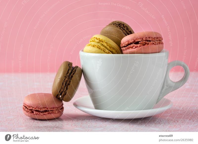 Colorful macarons in a cup on pink background Macaron Strawberry Lemon Dessert Coffee Yellow Chocolate Confectionary Raspberry Tradition Candy cut out cookies