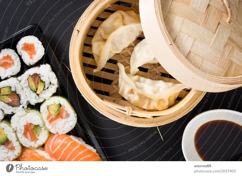 Dumplings or gyoza served in traditional steamer and sushi Sushi Vegetable Fish maki Food Healthy Eating Food photograph Rice Roll Seafood Tuna fish Salmon
