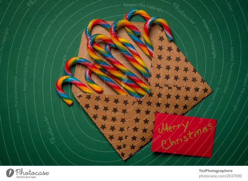 Rainbow candy canes and Merry Christmas message Candy Winter Feasts & Celebrations Christmas & Advent New Year's Eve Paper Brown Green Colour Tradition