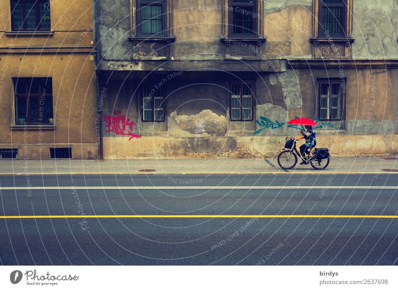Bicyclist with red umbrella in front of dilapidated building in urban space Lifestyle Feminine Woman Umbrella Adults 1 Human being 45 - 60 years Cycling