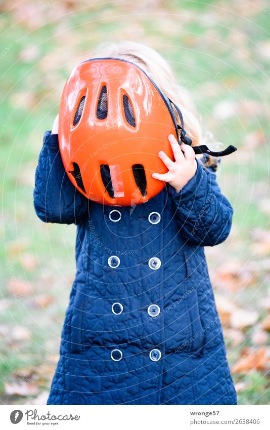 Girl with red bicycle helmet Cycling tour Human being Child 1 3 - 8 years Infancy Stand Blue Green Red Bike helmet To put on Helmet Protection Road safety