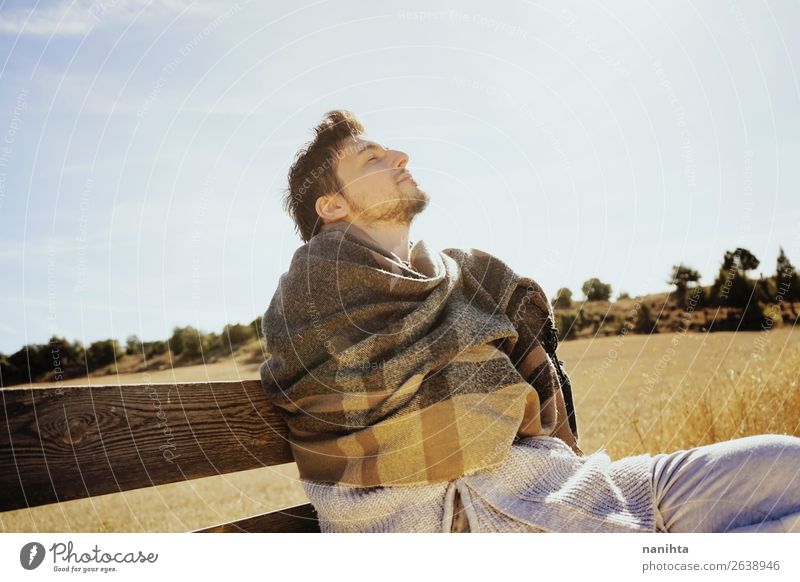 Side face of a young man with the eyes closed Lifestyle Happy Face Relaxation Calm Freedom Sunbathing Man Adults Sky Autumn Grass Scarf Wood To enjoy Sit Yellow