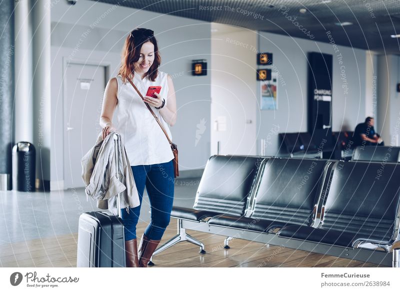 Woman with suitcase at the gate of an airport Lifestyle Style Feminine Adults 1 Human being 18 - 30 years Youth (Young adults) 30 - 45 years Vacation & Travel