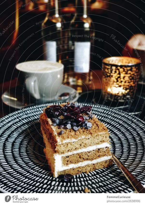 A delicious piece of cake on a plate in a café Food Nutrition To have a coffee Organic produce To enjoy Cake Cream Candlelight Cozy Decoration Coffee Coffee cup