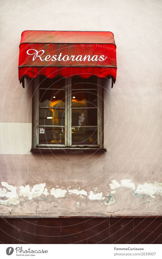 Window of a restaurant in Lithuania with red awning Nutrition Dinner Town Eating Restaurant Vilnius restoranas Characters Logo Inscription Sun blind Red Tavern