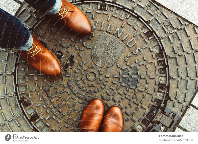 Two persons in brown leather shoes on manhole cover in Vilnius Elegant Style Masculine Feminine Woman Adults Man 2 Human being Vacation & Travel Gully