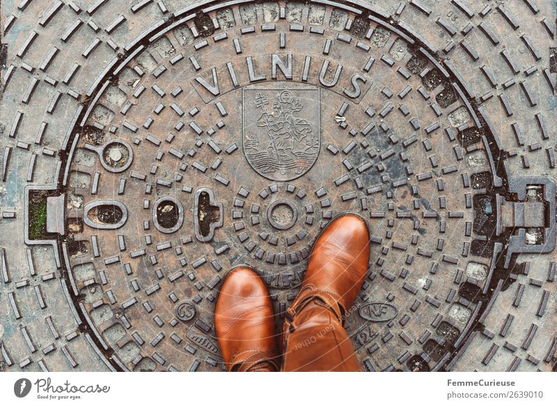 Person with brown boots standing on a manhole cover in Vilnius Lifestyle Feminine Young woman Youth (Young adults) Woman Adults 1 Human being Vacation & Travel