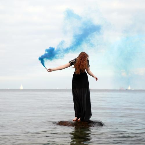 nina Feminine Woman Adults 1 Human being Water Sky Horizon Coast Baltic Sea Dress Red-haired Long-haired Curl Torch Smoke Movement To hold on Stand Maritime