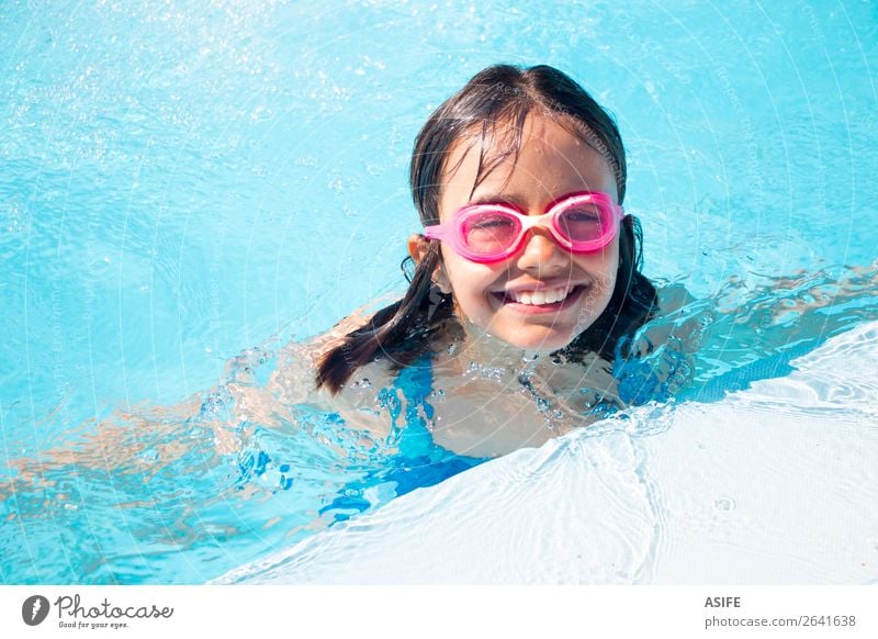 Funny little girl swimming in the pool Lifestyle Joy Happy Beautiful Relaxation Swimming pool Leisure and hobbies Playing Vacation & Travel Summer Sports Child