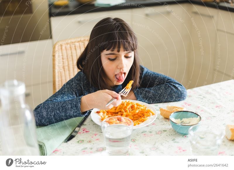 Little girl eating pasta at home Cheese Nutrition Eating Lunch Dinner Fork Joy Happy Beautiful Table Kitchen Child Sit Delicious Cute Appetite Macaroni penne