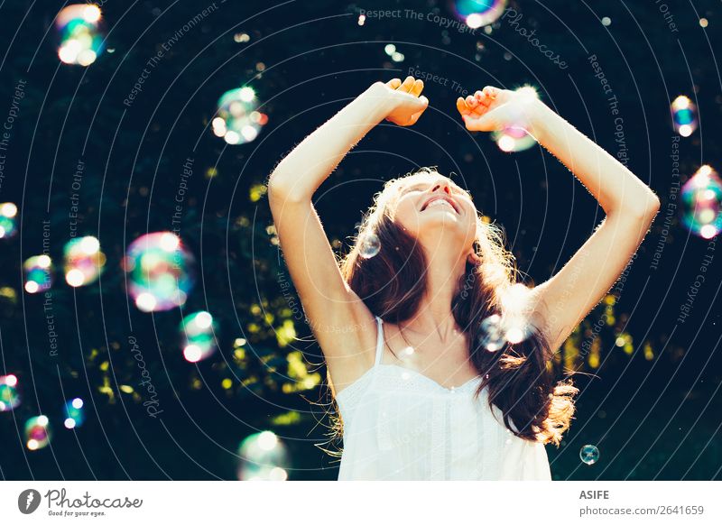 Girl having fun with bubbles Joy Happy Beautiful Playing Summer Feasts & Celebrations Human being Woman Adults Nature Warmth Park Dream Happiness Soft Green