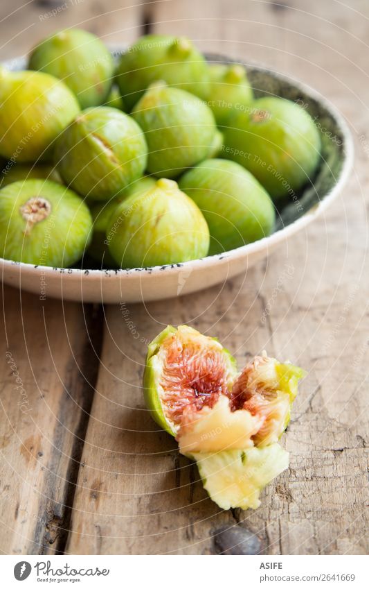 Figs on a rustic table and dish Fruit Diet Table Nature Wood Old Fresh Juicy Green Red figs Mature food healthy sweet Organic Mediterranean fiber Rustic Dish