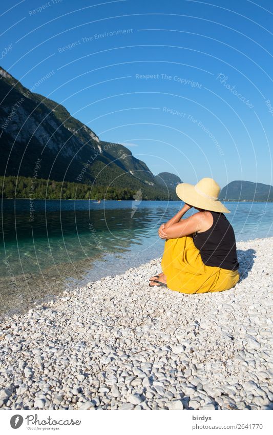 Woman with straw hat enjoys solitude at clear mountain lake Harmonious Vacation & Travel Summer vacation Sunbathing Feminine Adults 1 Human being Contentment