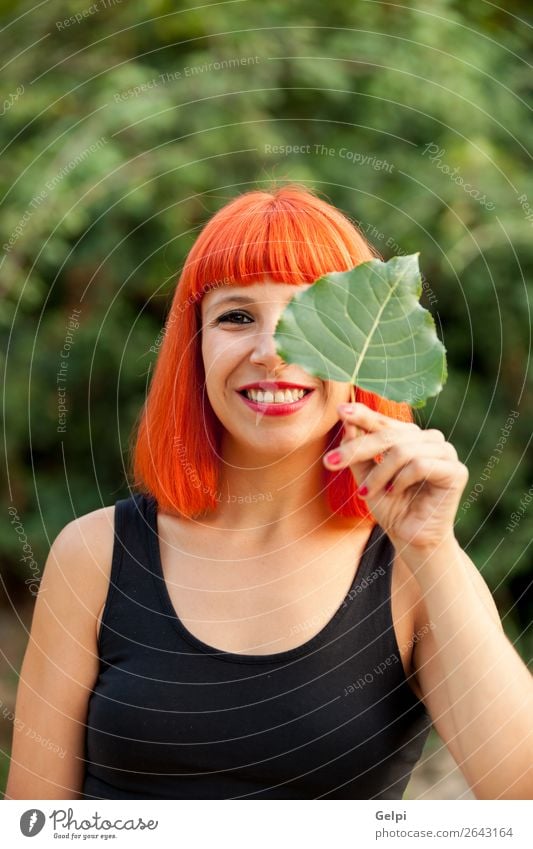 Red hair girl with a tree leaf Lifestyle Happy Beautiful Face Make-up Human being Woman Adults Nature Autumn Leaf Park Forest Fashion Smiling Happiness Colour