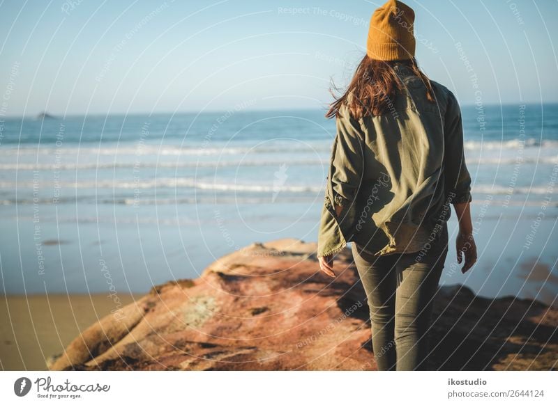 Woman with a yellow cap and walking over the cliff to see the beach Lifestyle Beautiful Vacation & Travel Adventure Freedom Beach Ocean Hiking Success