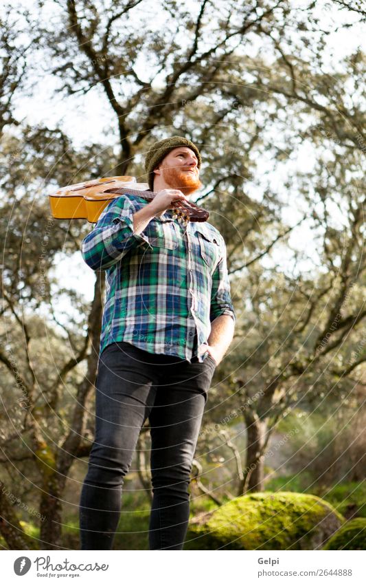 Hipster man with red beard and a guitar relaxs Leisure and hobbies Playing Entertainment Music Human being Man Adults Musician Guitar Nature Red-haired