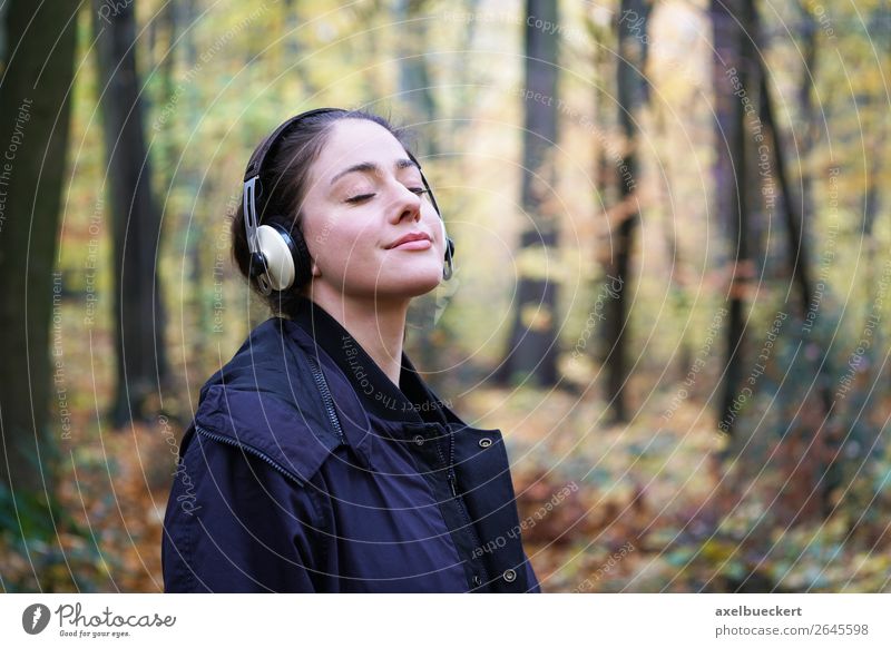 young woman with headphones in the forest Lifestyle Harmonious Well-being Contentment Relaxation Leisure and hobbies Entertainment Music Human being Feminine