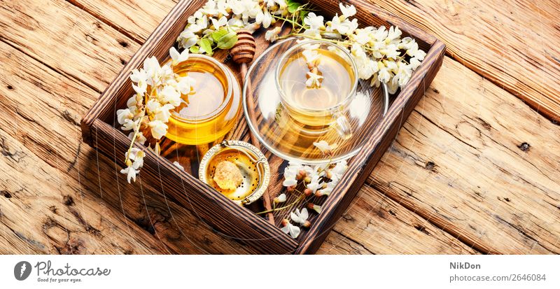 Tea with acacia flavor tea flower cup drink green table petal herbal tree nature leaf fresh spring healthy floral mug honey blossom glass concept natural bloom
