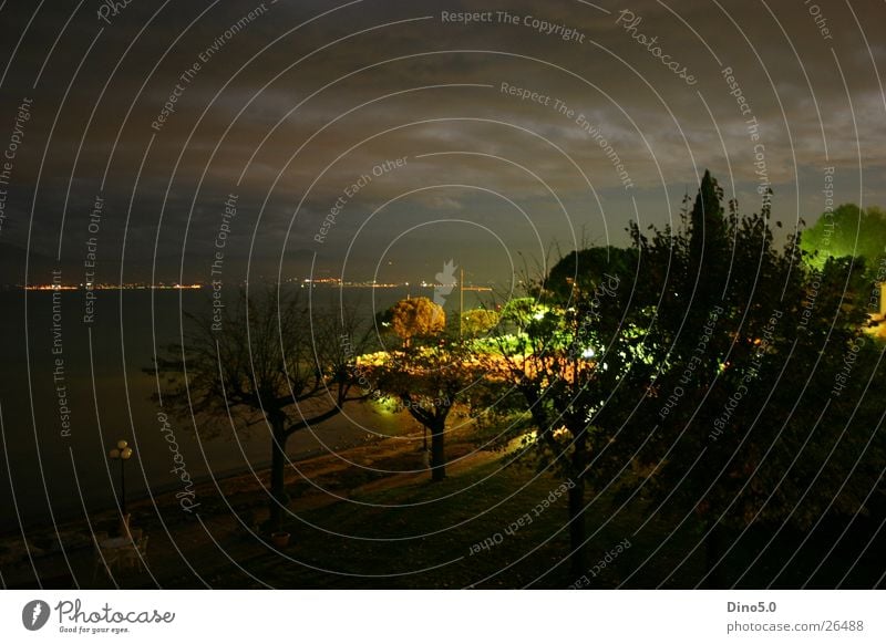 Lake Garda Nightshot Italy Light Long exposure Lamp Tree Clouds Storm Town Village Europe Water Coast