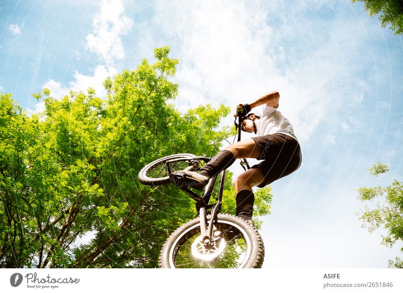 Cyclist extreme jumping Freedom Summer Mountain Sports Cycling Man Adults Nature Tree Forest Rock Jump Strong Rider bike Extreme bicycle young Motorcycling